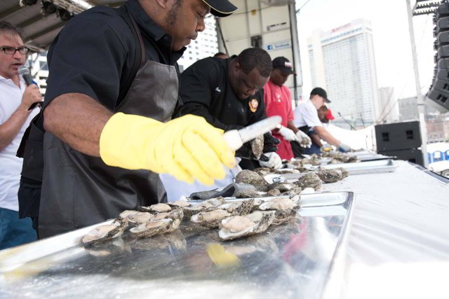 Oyster shuckers show off their skills during Oyster Fest. (Photo courtesy New Orleans Oyster Festival on Facebook)