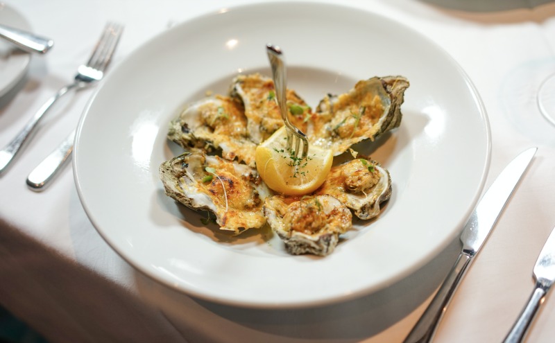 Enjoy the char-grilled oyster appetizer at Criollo Restaurant. (Photo: Paul Broussard)