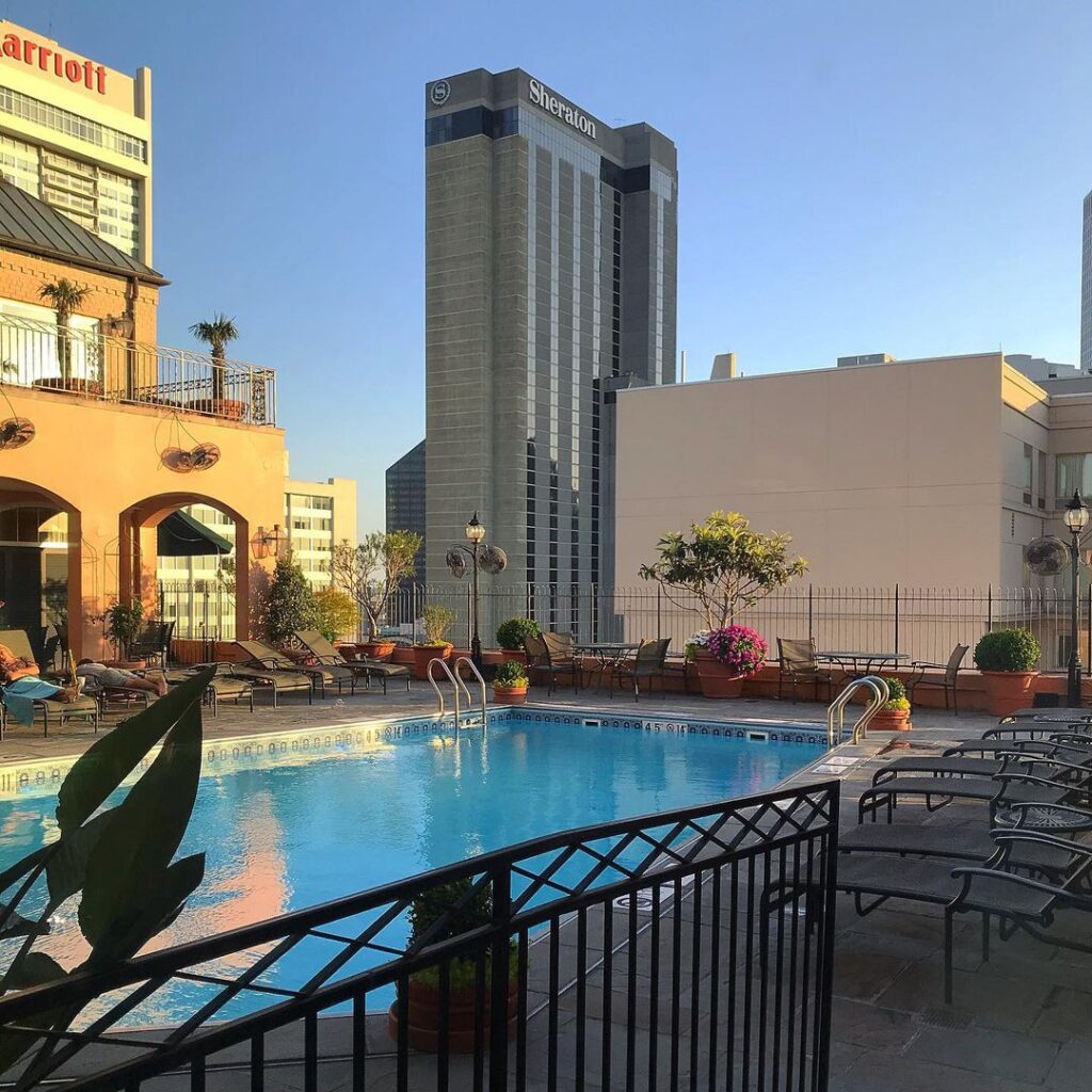 Photo of New Orleans French Quarter skyline. Hotel Monteleone's rooftop pool is featured front and center.