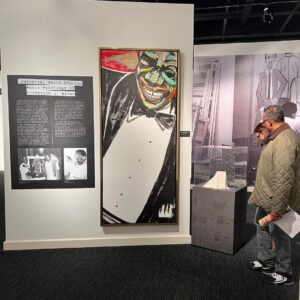 New Orleans Jazz Museum exhibit with black and white photos, paintings, and biography written out