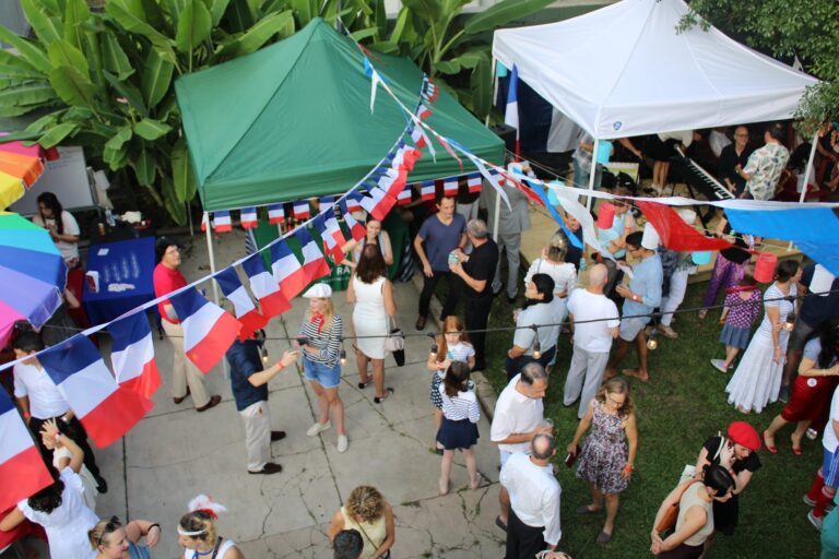 Courtyard of people celebrating Bastille Day at the Alliance Française of New Orleans